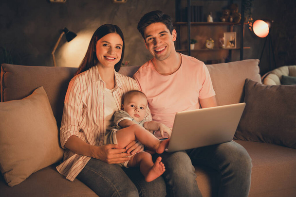 Portrait of attractive careful cheery family motherhood fatherhood parenthood nursery baby using laptop at home indoors. - Foto, afbeelding