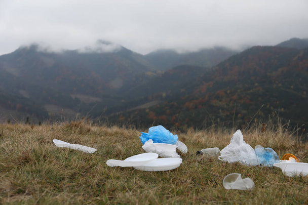 Plastic garbage scattered on grass in nature - Valokuva, kuva