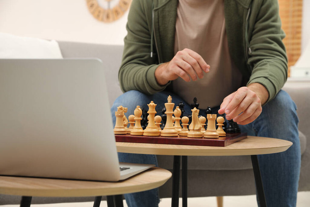 Man playing chess with partner through online video chat in living room, closeup - Φωτογραφία, εικόνα