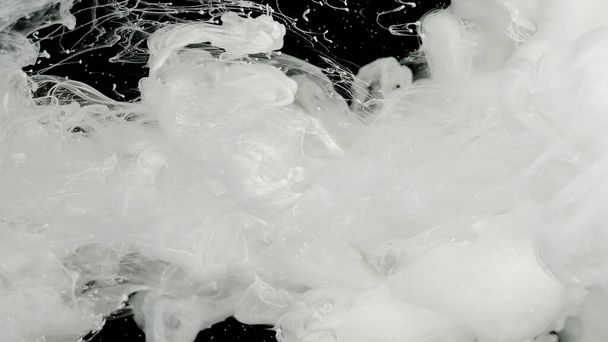 Milky white awesome abstract background. White cloud of ink, white smoke. Meditative background. White ink in water on a black background. Environmental pollution concept. - Photo, Image