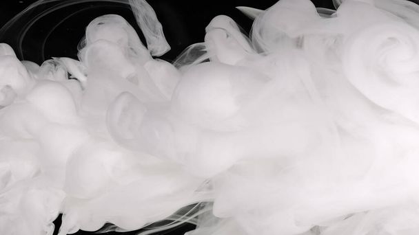 White cloud of ink. White acrylic ink in water on a black background. Beautiful milky white awesome abstract background. - Foto, Bild