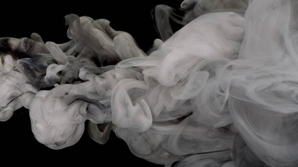 Beautiful milky white and black awesome abstract background. White cloud of ink. White and black acrylic paints are mixed in water on a black background. - Foto, immagini