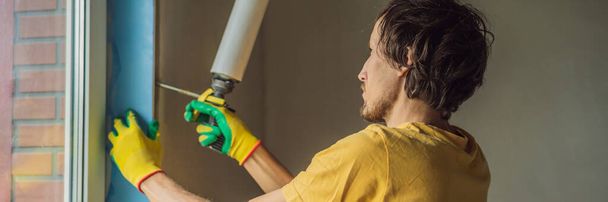 Builder or handyman is engaged in the repair or installation of windows BANNER, LONG FORMAT - Fotoğraf, Görsel