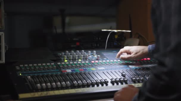 radio station, hand of sound engineer uses a music mixer with editing tools in production studio - Footage, Video
