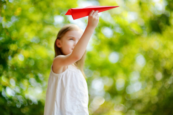 Girl holding paper plane - Valokuva, kuva