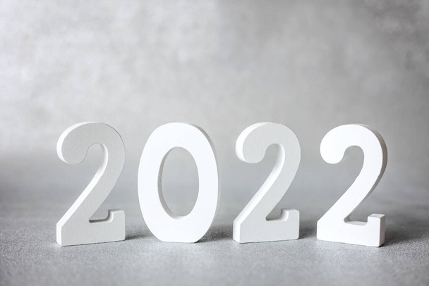 Decorative white wooden numbers 2022 isolated on grey background. Happy new year 2022. Banner - Foto, afbeelding