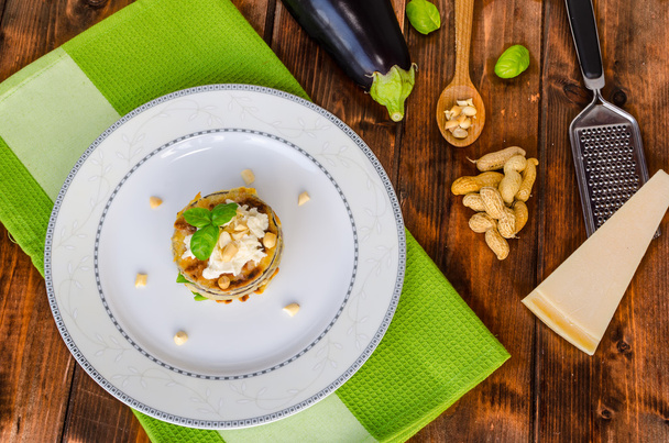 Grilled eggplant with feta cheese,parmesan basil, nuts - Foto, imagen