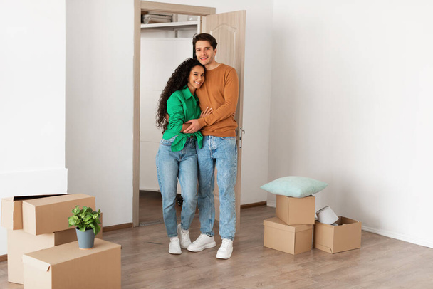Happy millennial couple posing on moving day in new flat - Photo, Image