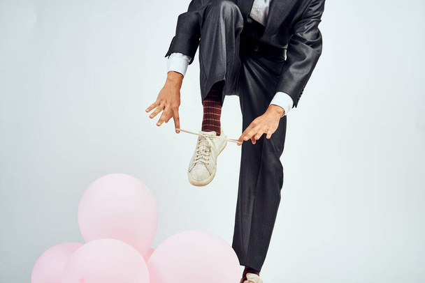 a man in a suit and sunglasses pink balloons manager holiday - 写真・画像