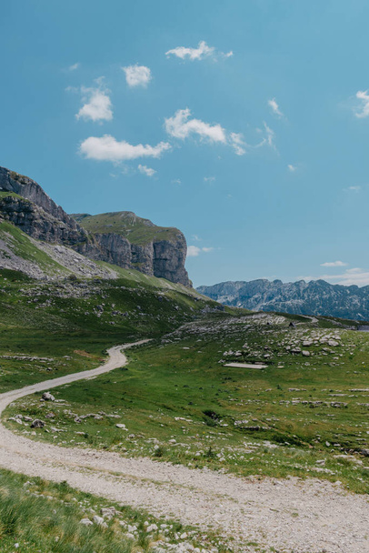 Amaizing view on Durmitor mountains, National Park, Mediterranean, Montenegro, Balkans, Europe. Bright summer view from Sedlo pass. The road near the house in the mountains. - Fotoğraf, Görsel