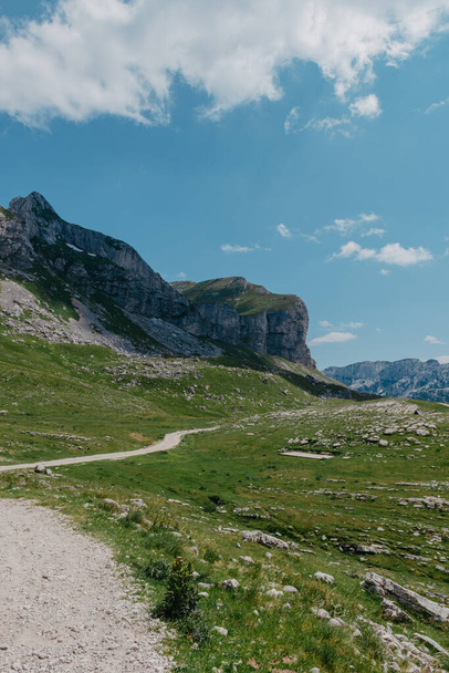 Amaizing view on Durmitor mountains, National Park, Mediterranean, Montenegro, Balkans, Europe. Bright summer view from Sedlo pass. The road near the house in the mountains. - Zdjęcie, obraz