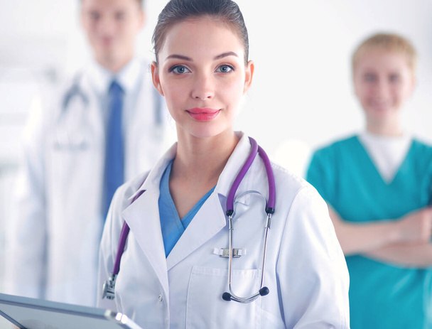 Woman doctor standing with folder at hospital - Photo, Image