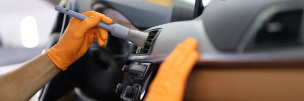 Male repairman cleaning air duct of car with brush closeup - Valokuva, kuva