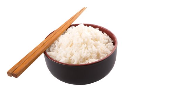 米と白い背景の上の箸のペアのボウル - 写真・画像