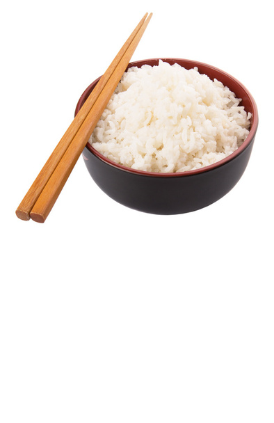 A bowl of rice and a pair of chopstick over white background - Foto, Imagem