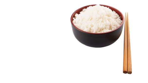 A bowl of rice and a pair of chopstick over white background - Φωτογραφία, εικόνα