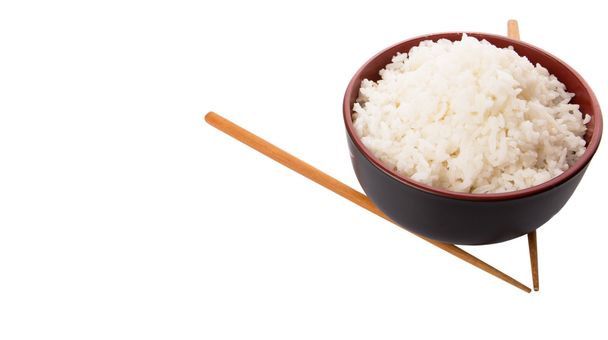 A bowl of rice and a pair of chopstick over white background - Photo, Image