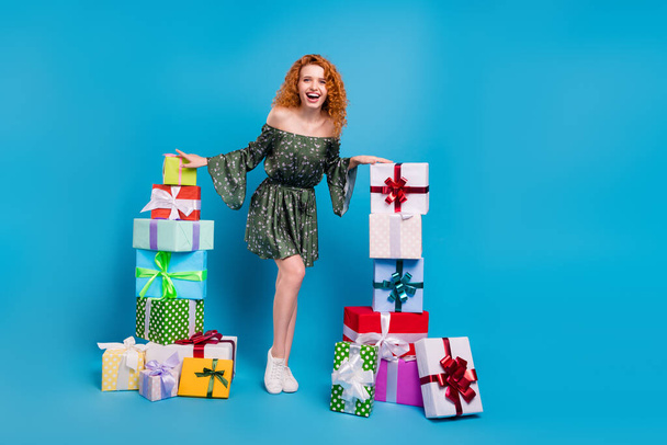 Full length photo of cool ginger hairdo lady hands presents wear dress isolated on blue color background - 写真・画像