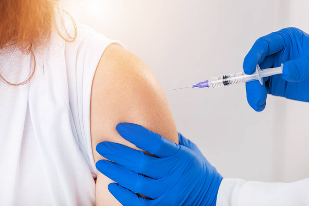 Patient taking vaccine from doctor - Photo, image