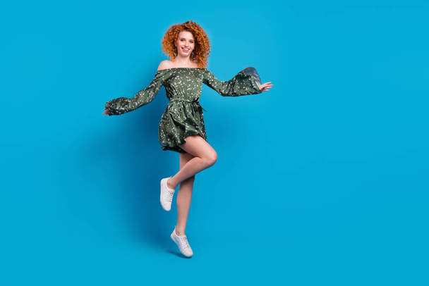 Full size photo of sweet ginger hairdo lady dance wear dress sneakers isolated on blue color background - 写真・画像