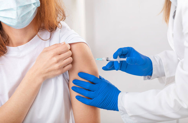 Doctor in gloves vaccinating patient - Zdjęcie, obraz
