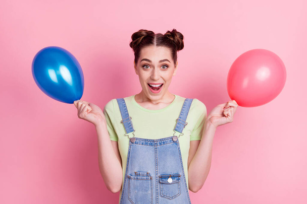 Photo portrait girl in overall keeping air balloon before party isolated pastel pink color background - Φωτογραφία, εικόνα