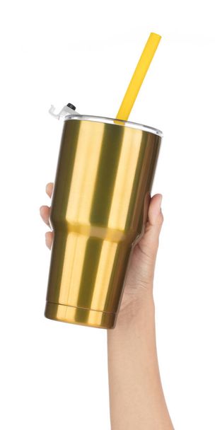 Hand holding Gold Yeti cup with tube isolated on white background. - Photo, Image