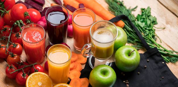 Freshly squeezed juices in glasses of farm vegetables and fruits on wooden rustic table. Vitamin summer diet. - Photo, image