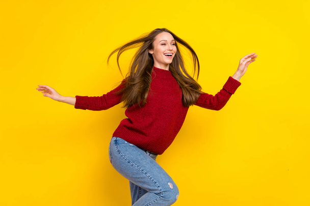 Photo of young cheerful woman happy positive smile fly air hair look empty space isolated over yellow color background - Foto, imagen