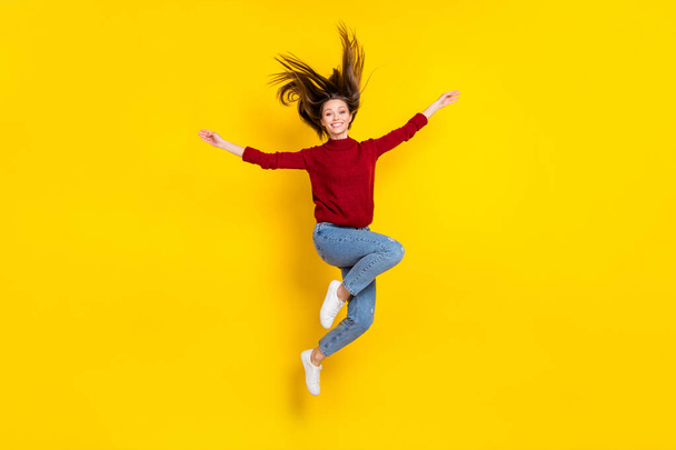 Full size photo of young attractive woman happy positive smile jump active isolated over yellow color background - Fotó, kép