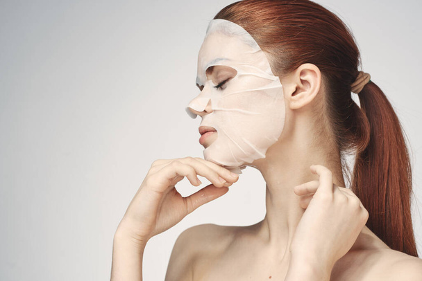 emotional woman cosmetic face mask close-up light background - 写真・画像
