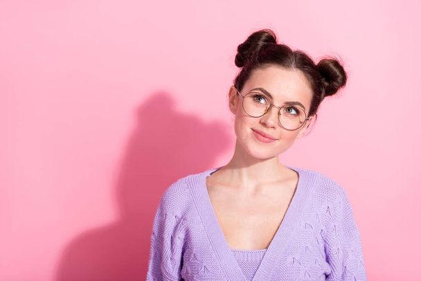 Photo portrait of pretty girl wearing purple cardigan looking empty space in glasses isolated on pastel pink color background - Fotó, kép