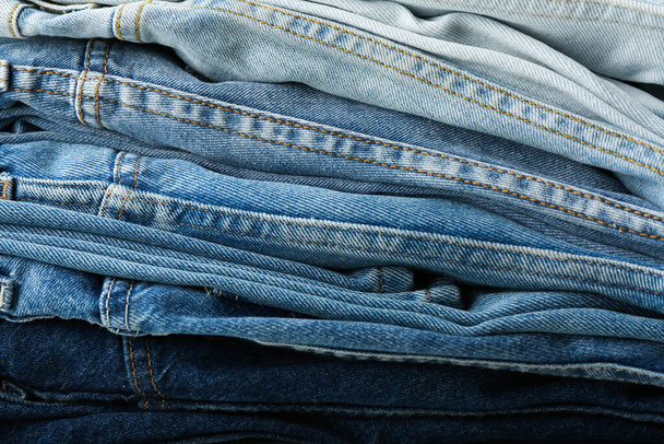 stack of blue jeans. Gradient - Foto, imagen