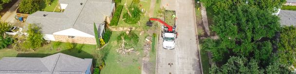 アメリカ、テキサス州ダラス近郊の郊外の家で木を切り落としたリフト付きのパノラマ航空ビュー作業トラック。住宅街の木の剪定造園サービス. - 写真・画像