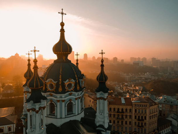 Aerial view from a drone of St. Andrew's Church in Kiev in autumn at sunset outdoor - Fotó, kép