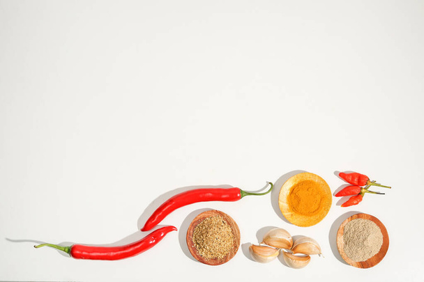 the assortment of spices and herbs on a white background with copy space. a simple culinary background decorated with condiment recipes. suitable for social media post or website presentation. - Foto, Imagen