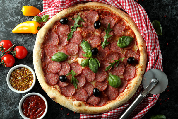 Concept of tasty food with Salami pizza on dark background - Photo, Image