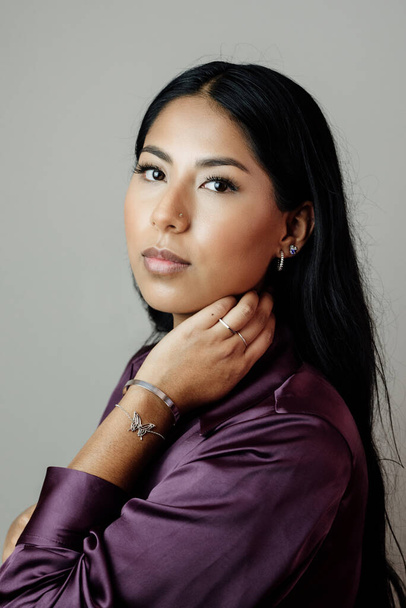 Latin woman with silver bracelet, rings and earrings. Model posing with jewelry - Foto, imagen
