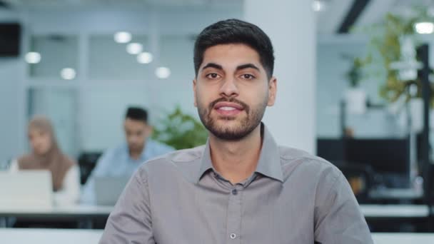 Freundlich lächelnde arabische Unternehmer sprechen junge männliche Top-Manager in die Kamera. Indischer Firmeninhaber, Geschäftsmann, Führungskraft, erfolgreicher Mitarbeiter, der über Arbeitsbedingungen oder neue Projekte spricht - Filmmaterial, Video