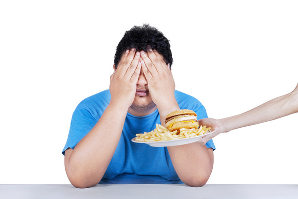 Fat man rejecting junk food 1 - Фото, изображение