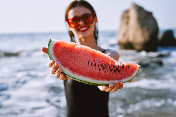 cheerful pretty woman in black swimsuit watermelon fashion travel - Foto, immagini