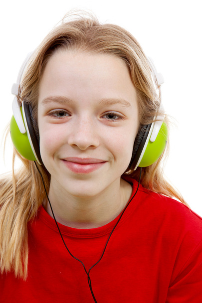 Girl is listening to music with headphones on - Фото, зображення