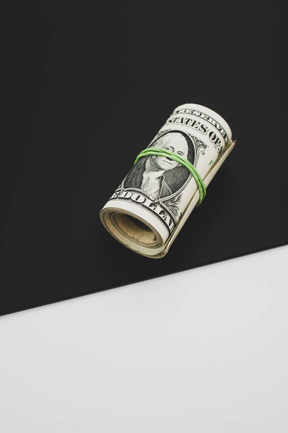 rolled up US dollar banknotes on  black white background with text space - Foto, Imagen
