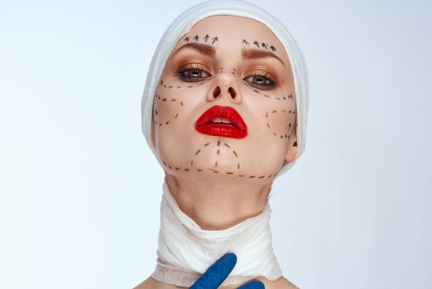 portrait of a woman in blue gloves syringe in hands contour on the face lifting close-up - Фото, изображение