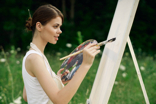 woman outdoors paint a picture landscape hobby creative - Foto, Imagen