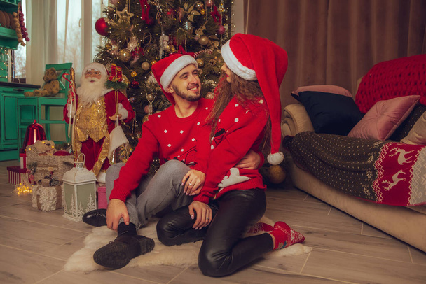 horizontal portrait of cute couple in love celebrate New year and Christmas together at home - Foto, Imagen