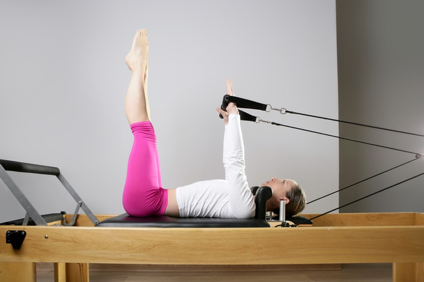Gym woman pilates stretching sport in reformer bed - Foto, imagen