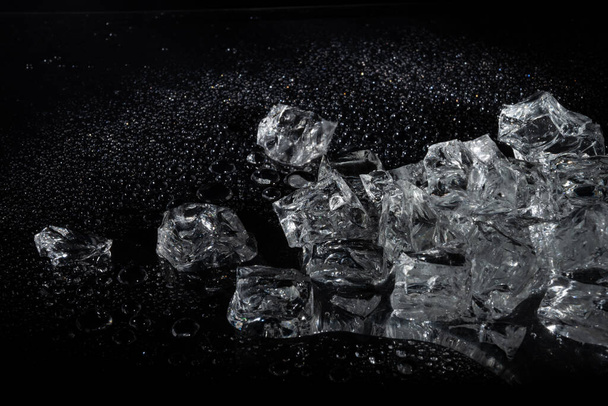 Ice cubes filling with smoke on a dark background - Photo, Image