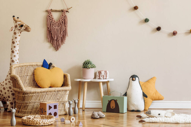 Stylish scandinavian interior of child room with natural toys, hanging decoration, design furniture, plush animals, teddy bears and accessories. Beige walls. Interior design of kid room. Template. - Foto, imagen