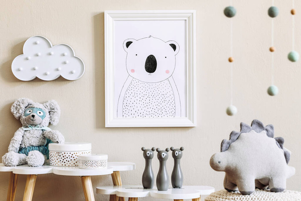 Stylish scandinavian nursery interior with mock up photo frame, toy, design furniture, pillows and accessories. Beautiful decoration on the beige background wall. Home decor for children room. - 写真・画像